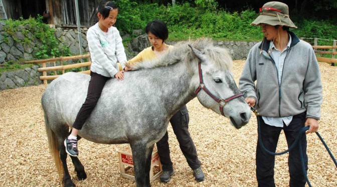 黍原豊さん（右）が引く馬に乗り、何ともいえない心地良い感覚に身をゆだねた乗馬体験