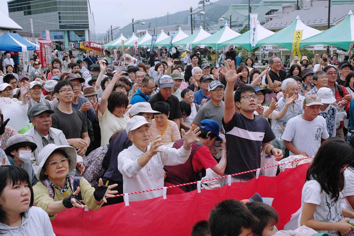 農業祭の野菜・餅まきは今年も大盛況。釜石の恵みをゲットしようと両手を伸ばす来場者