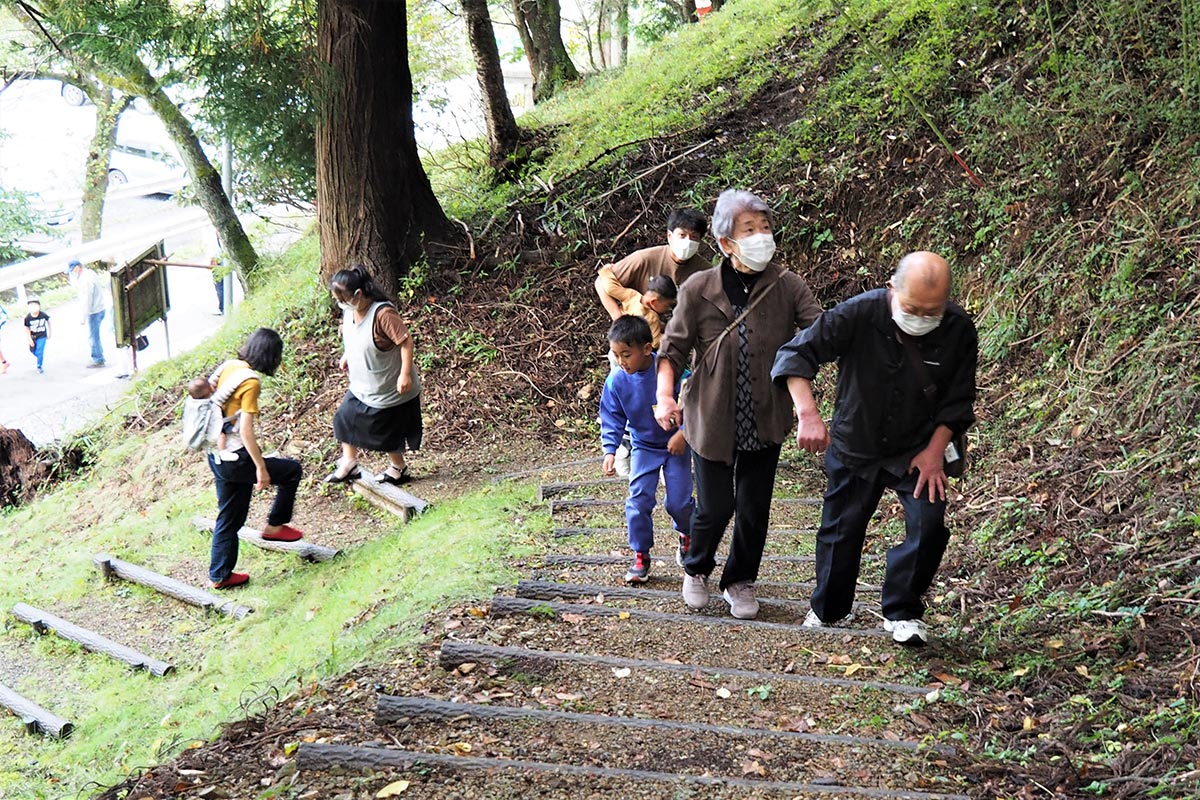 八雲神社境内に続く参道の階段を上る参加者
