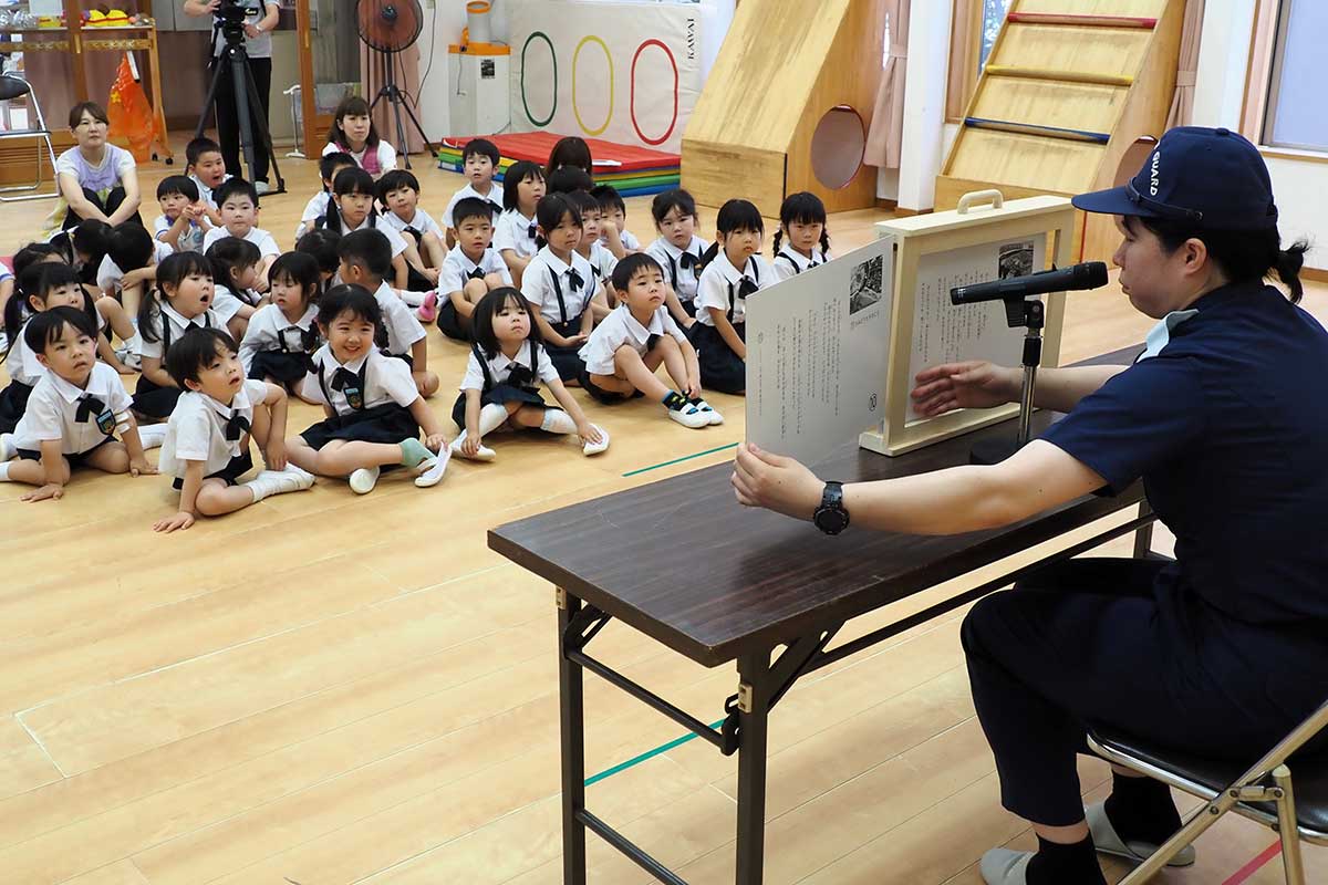 紙芝居を楽しみながら海の環境を守る大切さを学ぶ園児ら