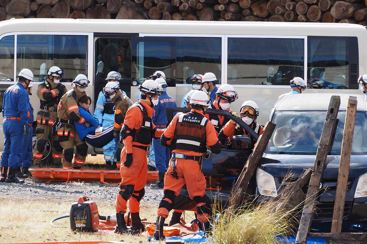 車内に閉じ込められた人を救出する消防隊員ら=港町会場