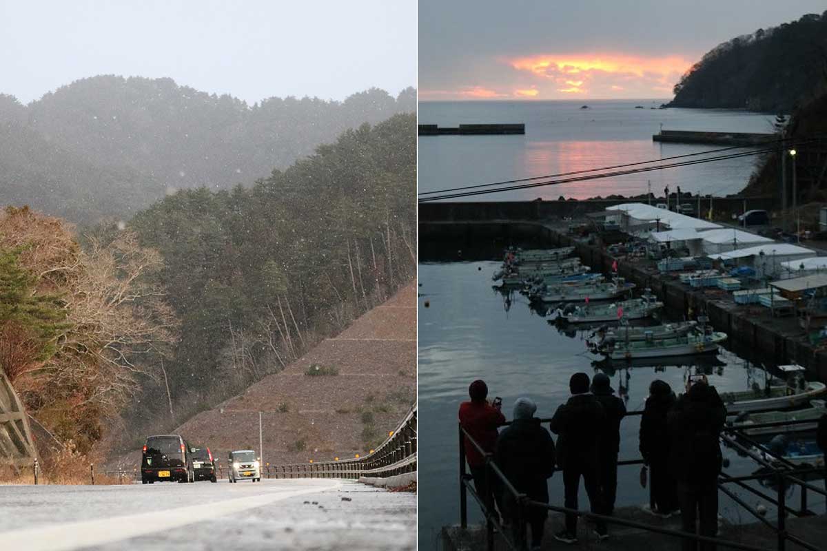 雪模様となった元日早朝。両石港で初日の出を待つ人たち＝午前7時前
