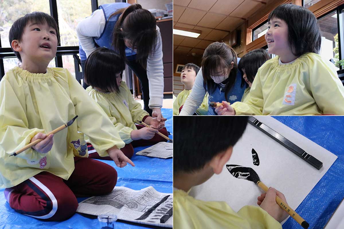 「先生、書けたよ!」。初めての筆文字に笑顔を広げる園児