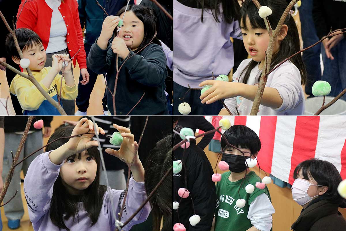4色の団子をミズキの枝に飾り付ける子どもら。「うまくできるかな？」