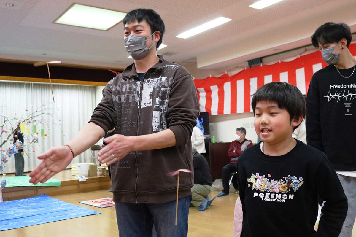 竹とんぼを飛ばしてみる親子。この日はお手玉などの昔遊びも用意され、楽しい時間を過ごした