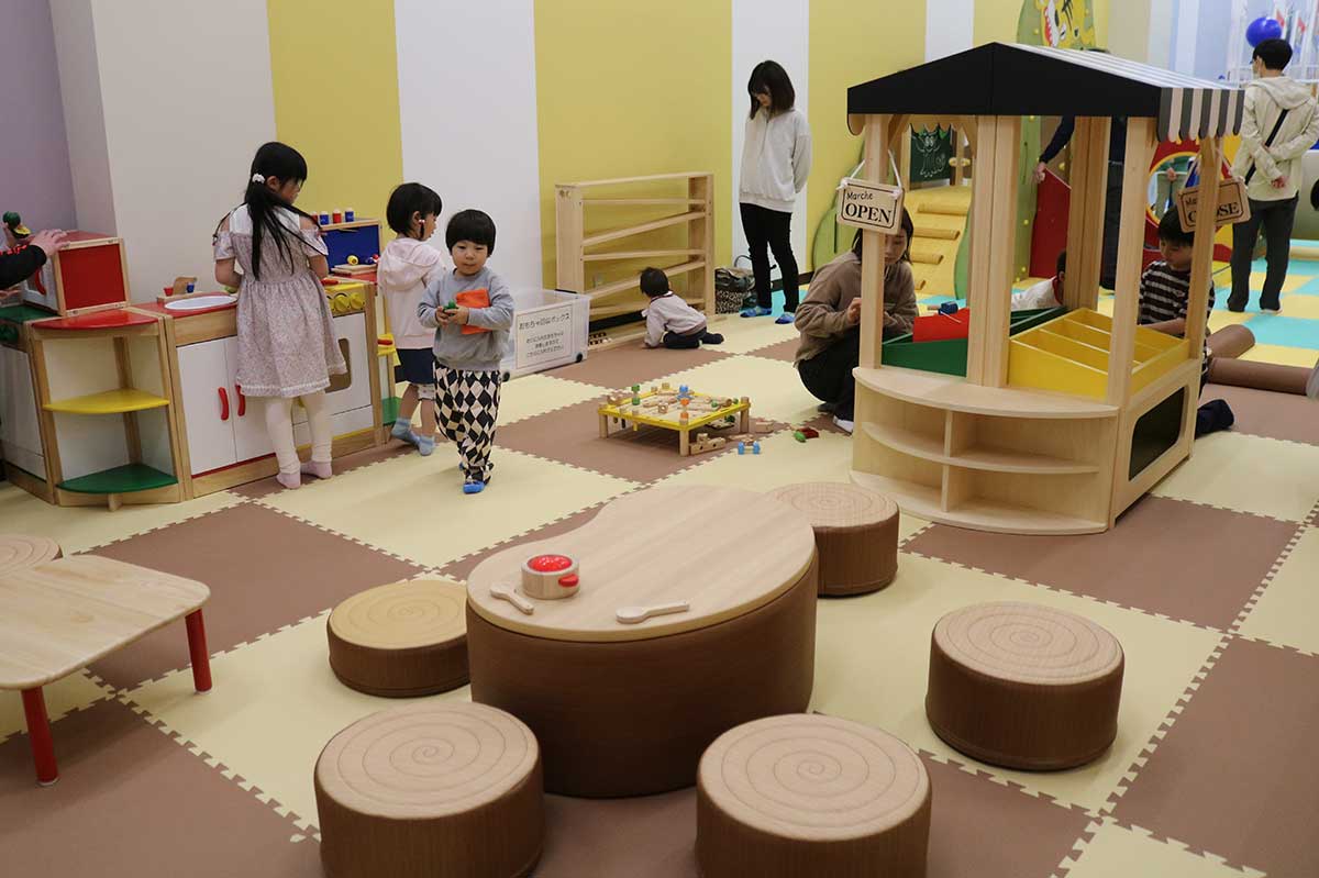 マルシェワゴン（右上）や、ままごとキッチン（左上）、切り株テーブルが並ぶおはなのひろば