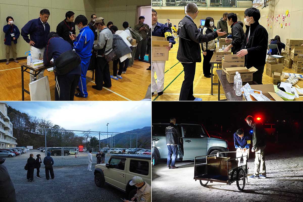 避難者の受け入れや物資の配布を行う市職員ら。校庭には避難車両が並び、車内で待機する人にも水などを配った