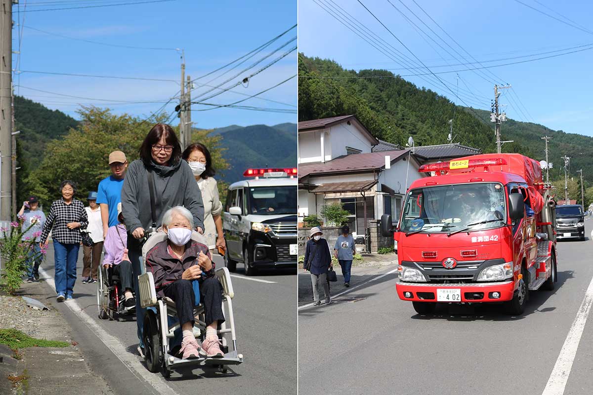 川から離れた高台の道路を通って避難する住民ら